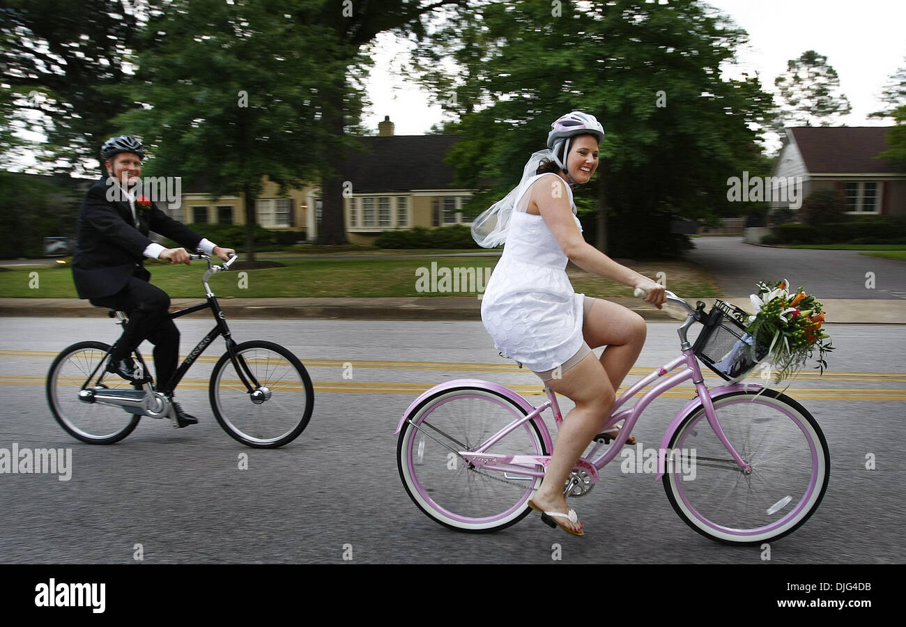 July 10, 2010 - Memphis, TN, U.S. - 10 July 10 (mwride) photo by Mark Weber - Newlyweds Frankie Allen, left, and his bride Virginia, right, lead a bike parade after their wedding ceremony at Christ United Methodist Church to a reception in East Memphis Saturday afternoon. The couple met last year while attending regular night bike rides from the Peddler Bike Shop to Overton Park an Stock Photo