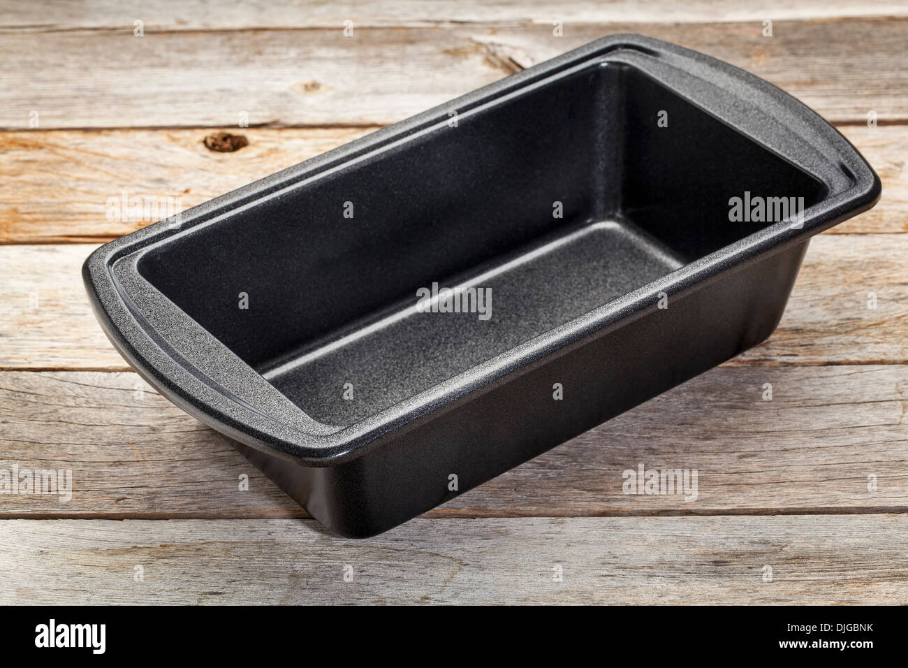 nonstick metal baking loaf pan on a wooden rustic table Stock Photo