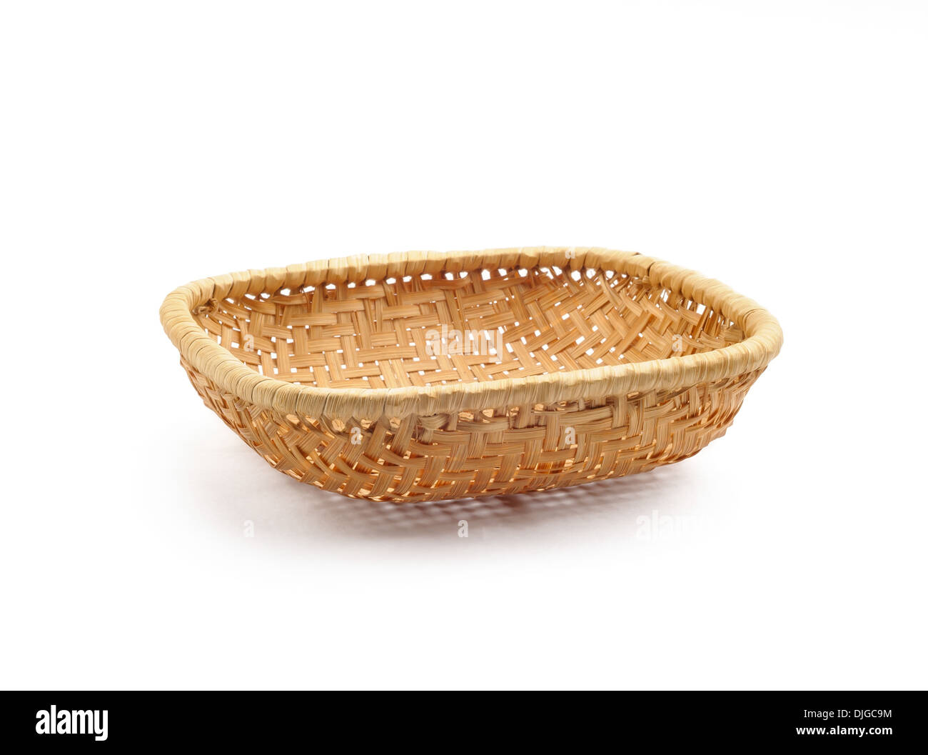 A little wicker basket isolated on white background Stock Photo