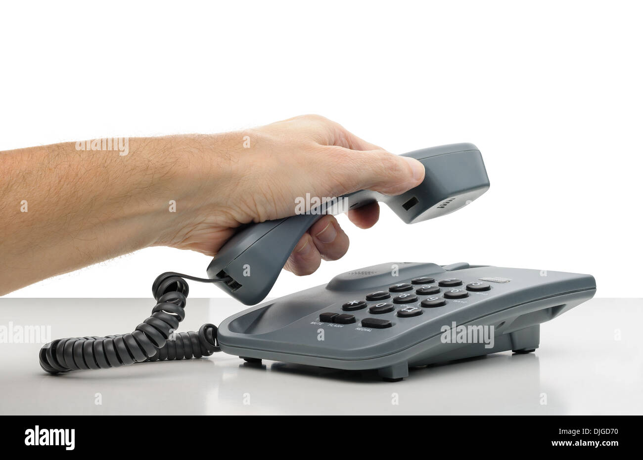 A man's hand hanging the phone receiver Stock Photo