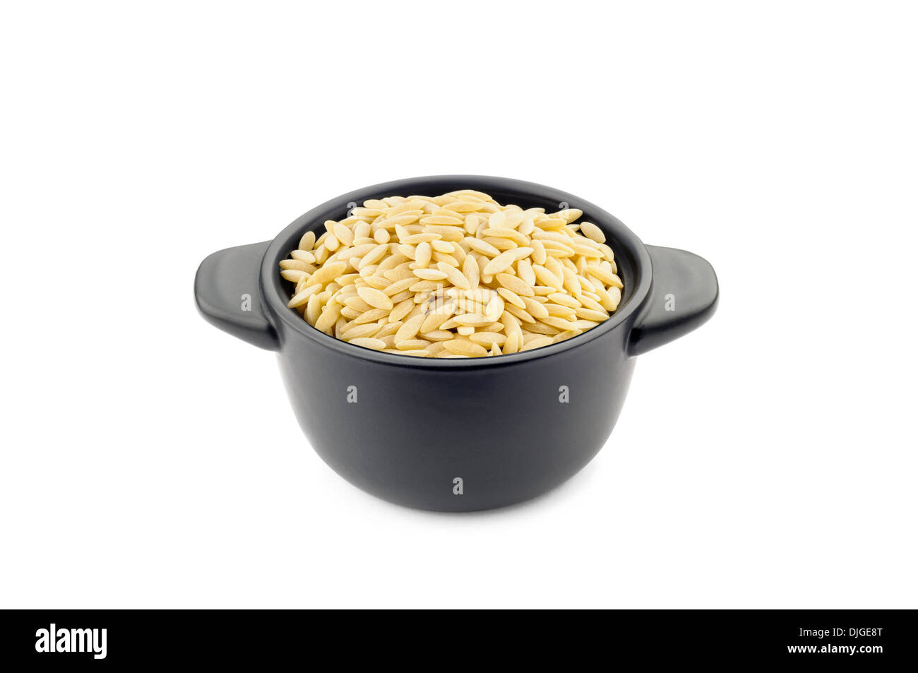 Pasta 'orzo' type in a little black ceramic dish, good for soup and minestrone Stock Photo