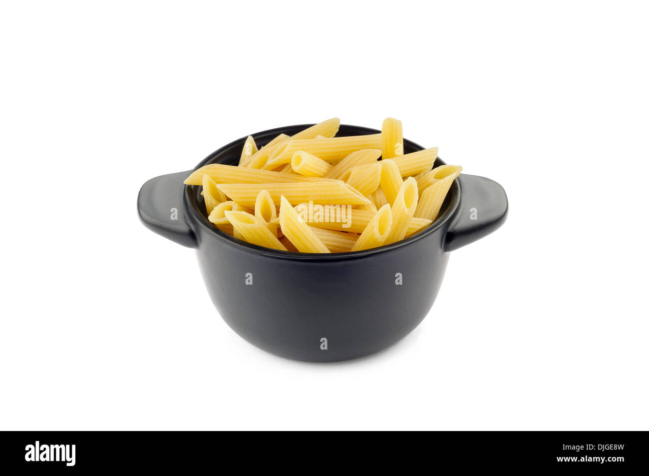 A black ceramic dish full of italian penne rigate Stock Photo