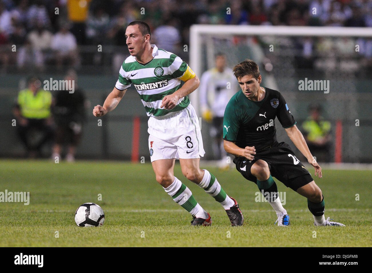 July 21, 2010 - Boston, Massachusetts, United States of America - 21 July 2010: Celtic midfielder Scott Brown (8) works the ball past Sporting midfielder Miguel Veloso (24). Celtic FC defeated Sporting 6 - 5 in penalty kicks, with a final 1 - 1 score during an international friendly at Fenway Park, Boston, Massachusetts to win the first Fenway Football Challenge..Mandatory Credit:  Stock Photo