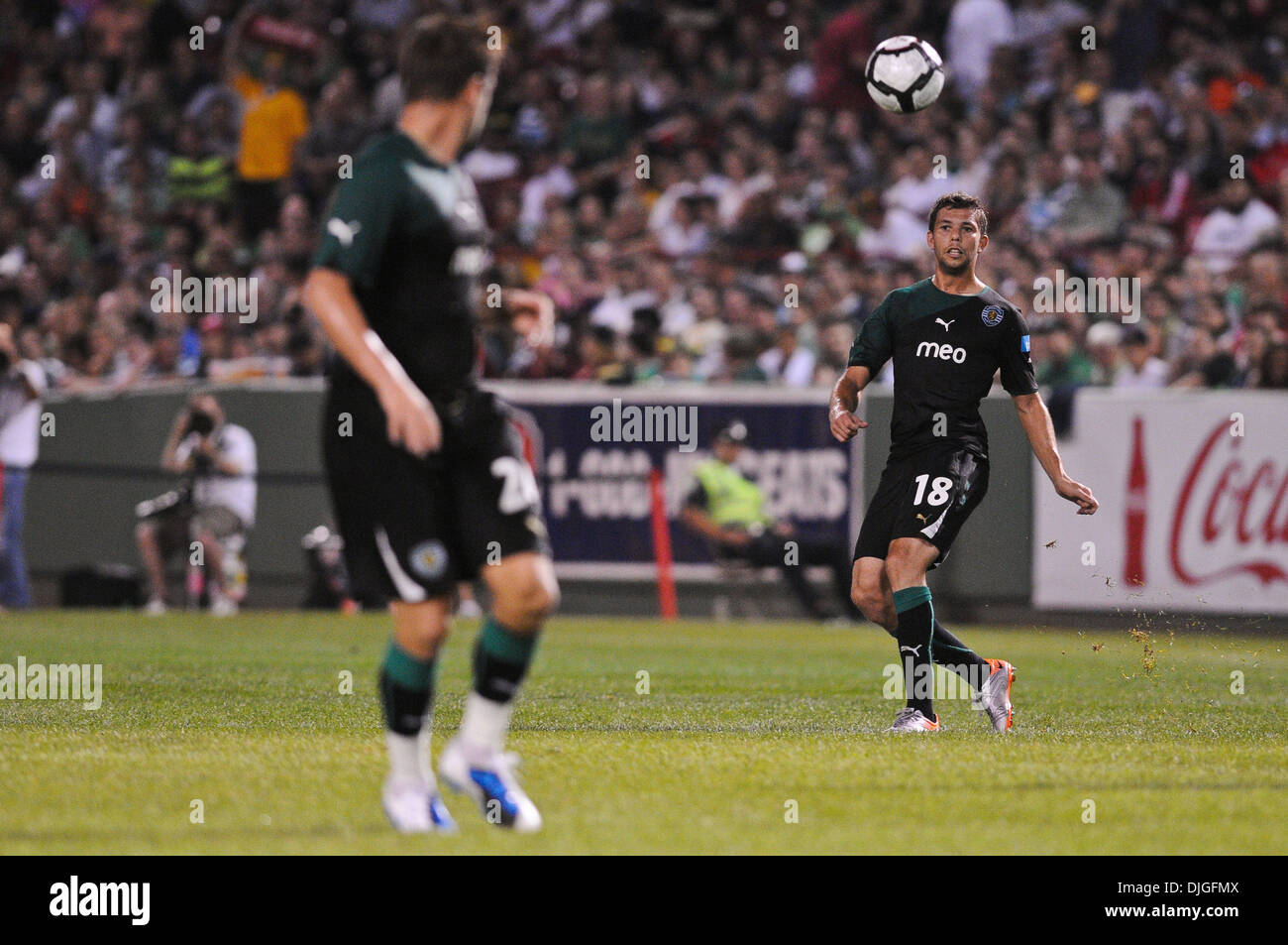July 21, 2010 - Boston, Massachusetts, United States of America - 21 July 2010: Sporting defender Leandro Grimi (18) passes the ball to midfielder Miguel Veloso (24, foreground). Celtic FC defeated Sporting 6 - 5 in penalty kicks, with a final 1 - 1 score during an international friendly at Fenway Park, Boston, Massachusetts to win the first Fenway Football Challenge..Mandatory Cre Stock Photo