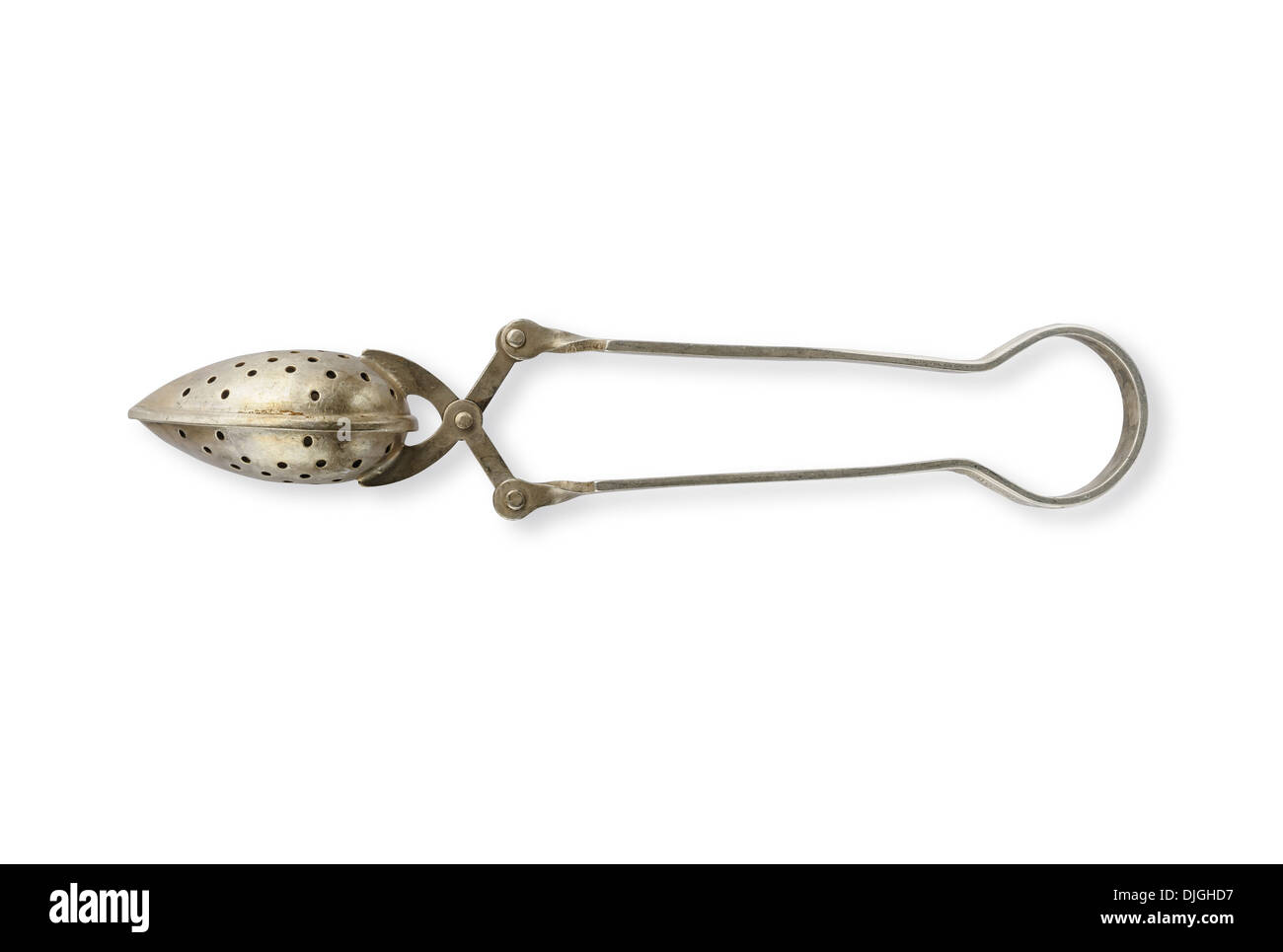 An antique tea strainer in silver metal Stock Photo