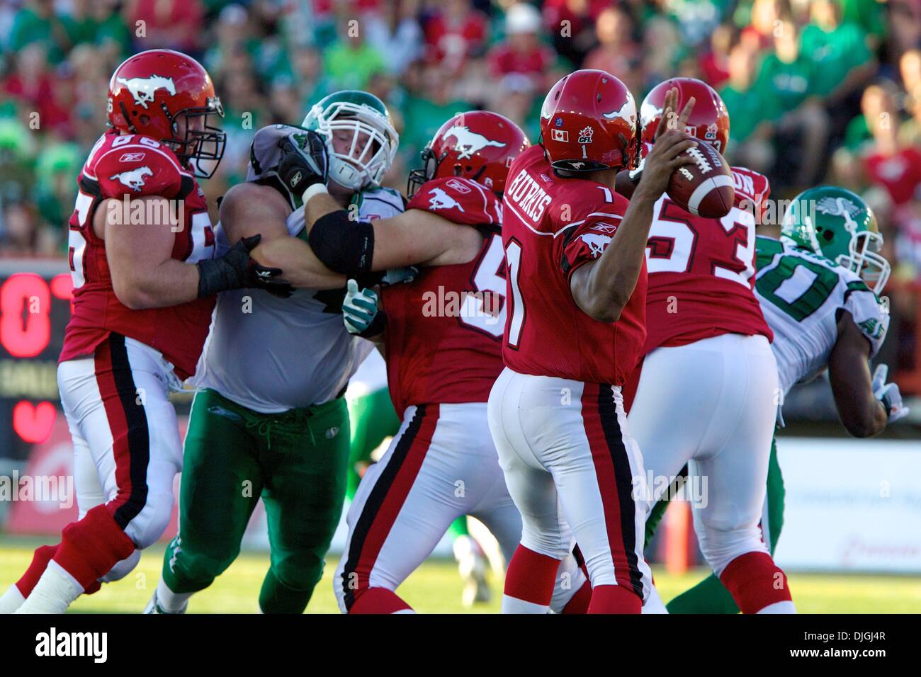 July 24, 2010 - Calgary, Alberta, Canada - 24 July 2010: Calgary Stampeders quarterback Henry Burris (1) looks to make a pass while his teammates offensive linemen Tim O'Neill (66),  Steve Myddelton (59) and Edwin Harrison (53) block a Saskatchewan Roughriders defensive tackle Keith Shologan (74) during a game at McMahon Stadium in Calgary, Alberta..Mandatory Credit: Irena Thompson Stock Photo
