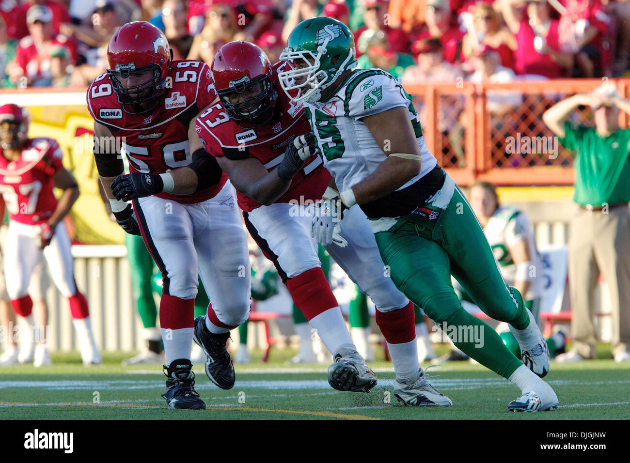 Calgary Stampeders offensive lineman Edwin Harrison (53) moves to block Saskatchewan Roughriders defensive end Luc Mullinder (95) during a game at McMahon Stadium in Calgary, Alberta. (Credit Image: © Irena Thompson/Southcreek Global/ZUMApress.com) Stock Photo