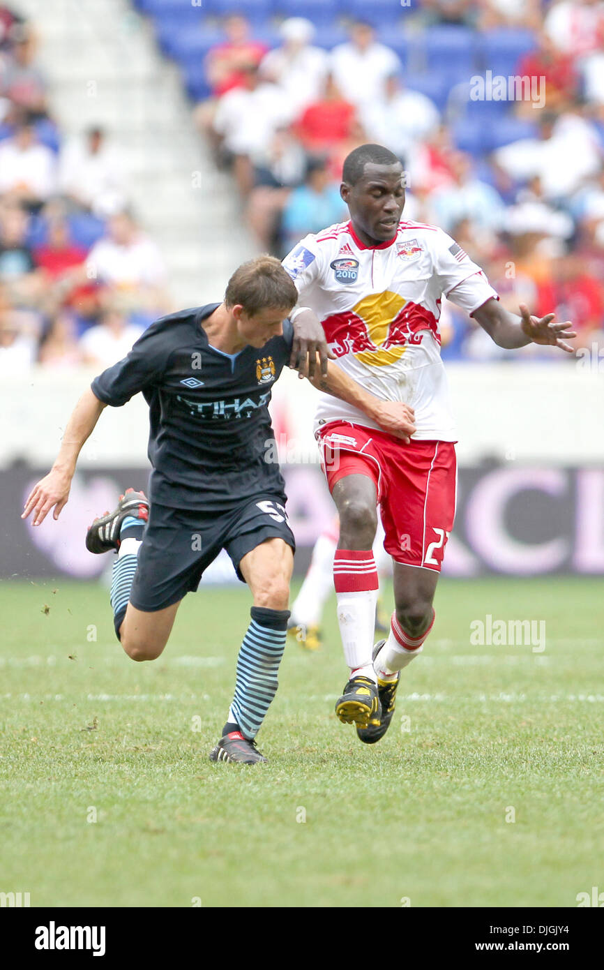 July 25, 2010 - Harrison, New Jersey, United States of America - 25  July 2010:  New York Red Bulls midfielder Tony Tchani  (#23) is held off by Manchester City forward Alex Nimely (#52).  The Red Bulls defeated Manchester City 2-1 in the game held at the Barclay Challenge, Red Bull Arena, Harrison, NJ..Mandatory Credit: Anthony Gruppuso / Southcreek Global. (Credit Image: Â© South Stock Photo