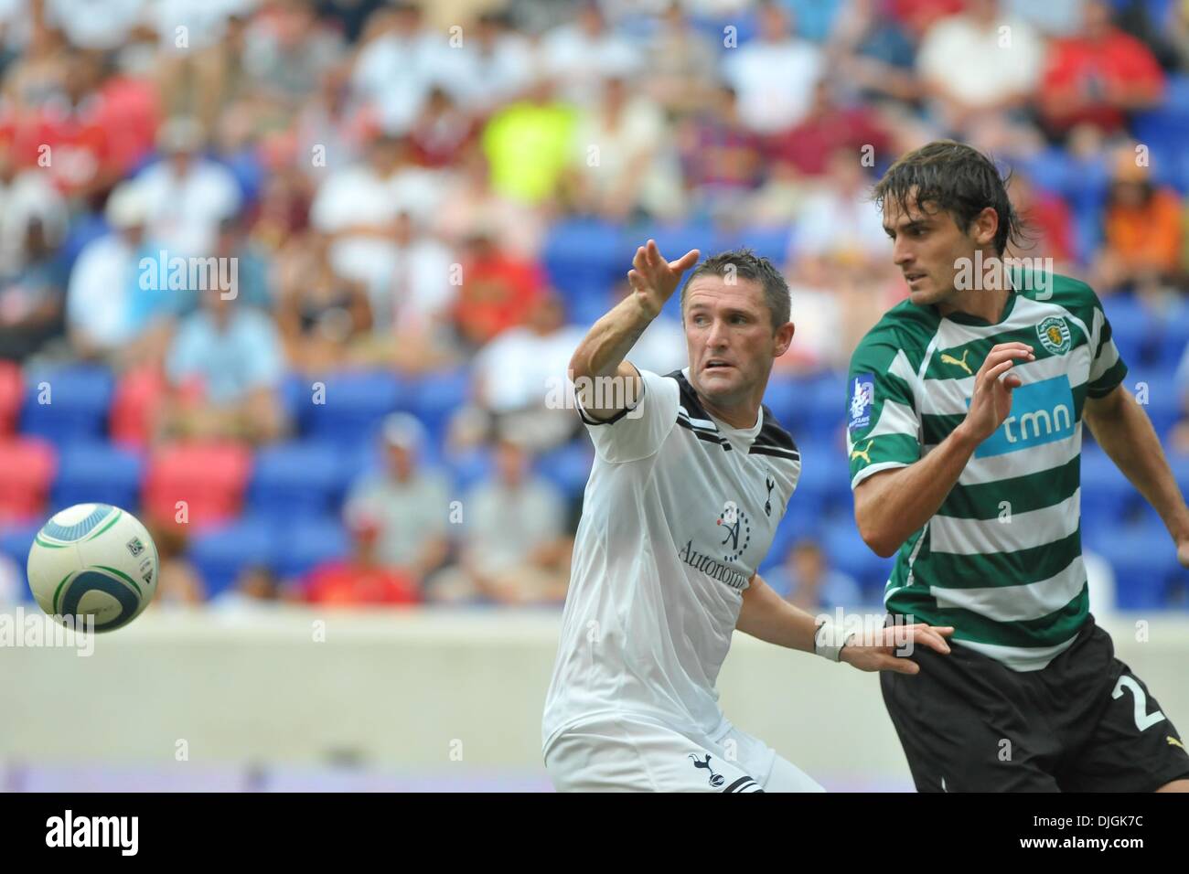 July 25, 2010 - Harrison, New Jersey, United States of America - 25 July 2010 -Tottenham Hotspur FC Striker Robbie Keane (#10) and Sporting Lisbon Defender Miguel Veloso (#24) fight for control as English Premier League Club Tottenham Hotspur face Super Liga club Sporting Club de Portugal in third match of the The Barclays New York Football Challenge at Red Bull Stadium in Harrison Stock Photo
