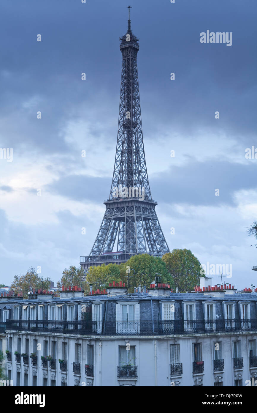 The Eiffel Tower rises above the rooftops on a dreary November morning. Stock Photo