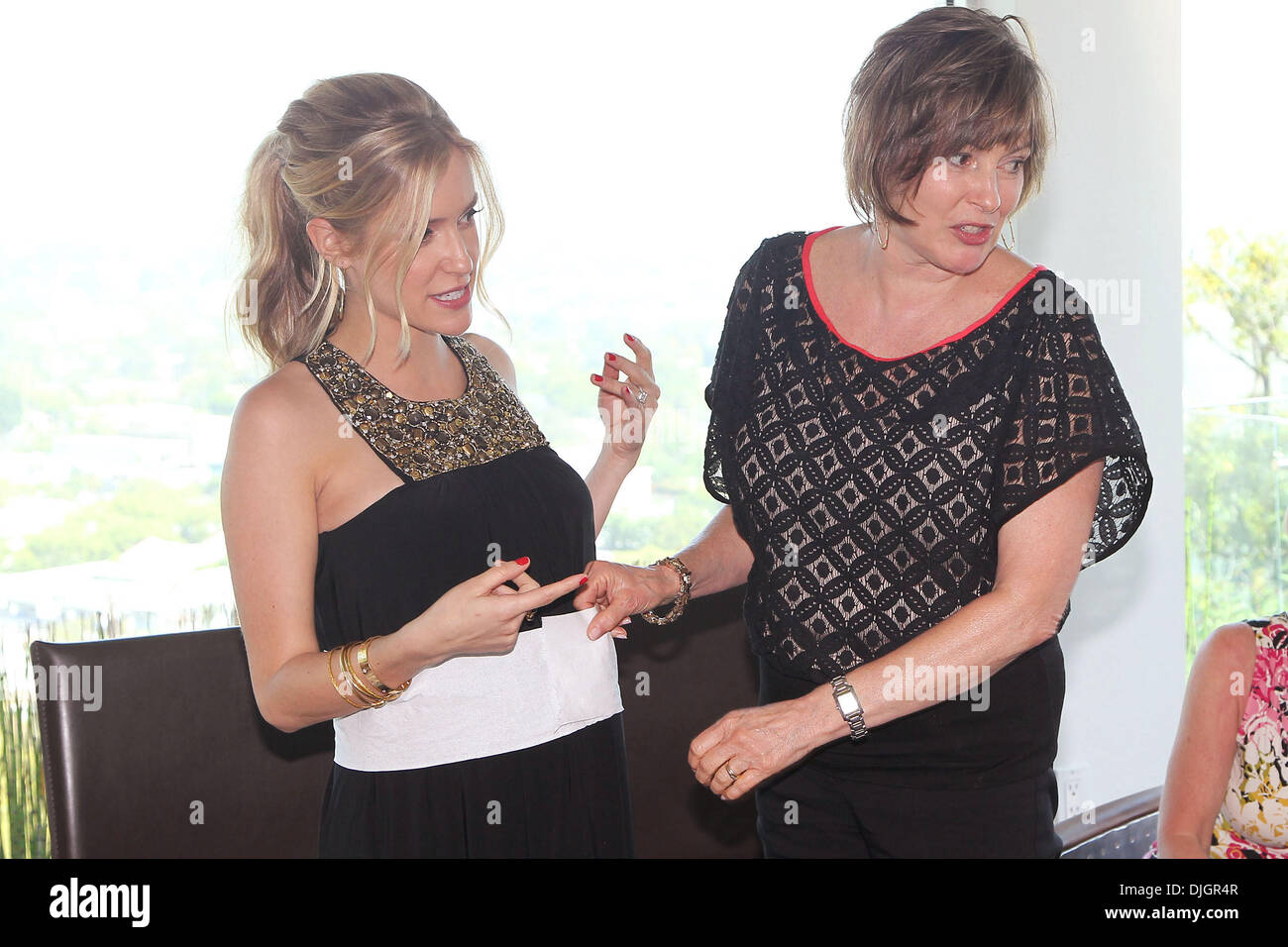 Kristin Cavallari opens gifts at her baby shower with her mother Stock