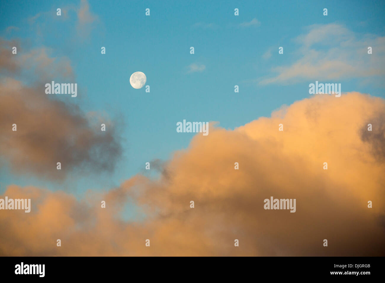 A near full moon setting in the morning over Loughrigg in Ambleside