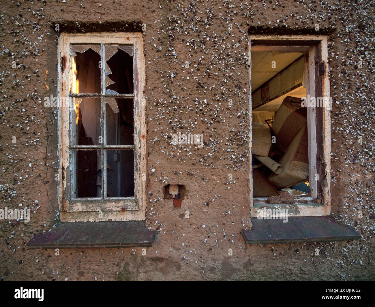 Broken windows in a derelict house in southern England Stock Photo