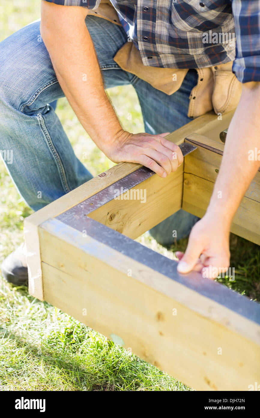 Manual Worker Measuring Wood With Scale At Construction Site Stock ...
