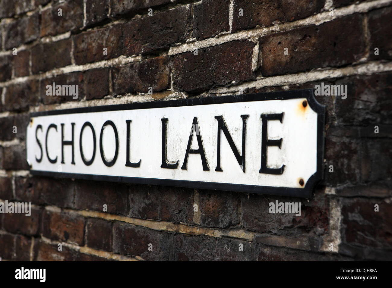 School Lane sign on a brick wall in Arundel England UK Stock Photo