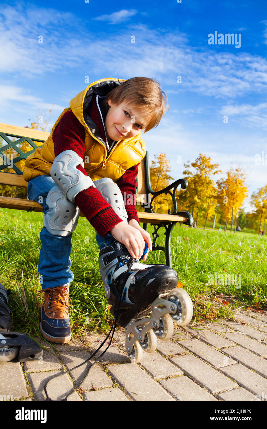 Close portrait of 10 years old boy in casual autumn clothes putting on