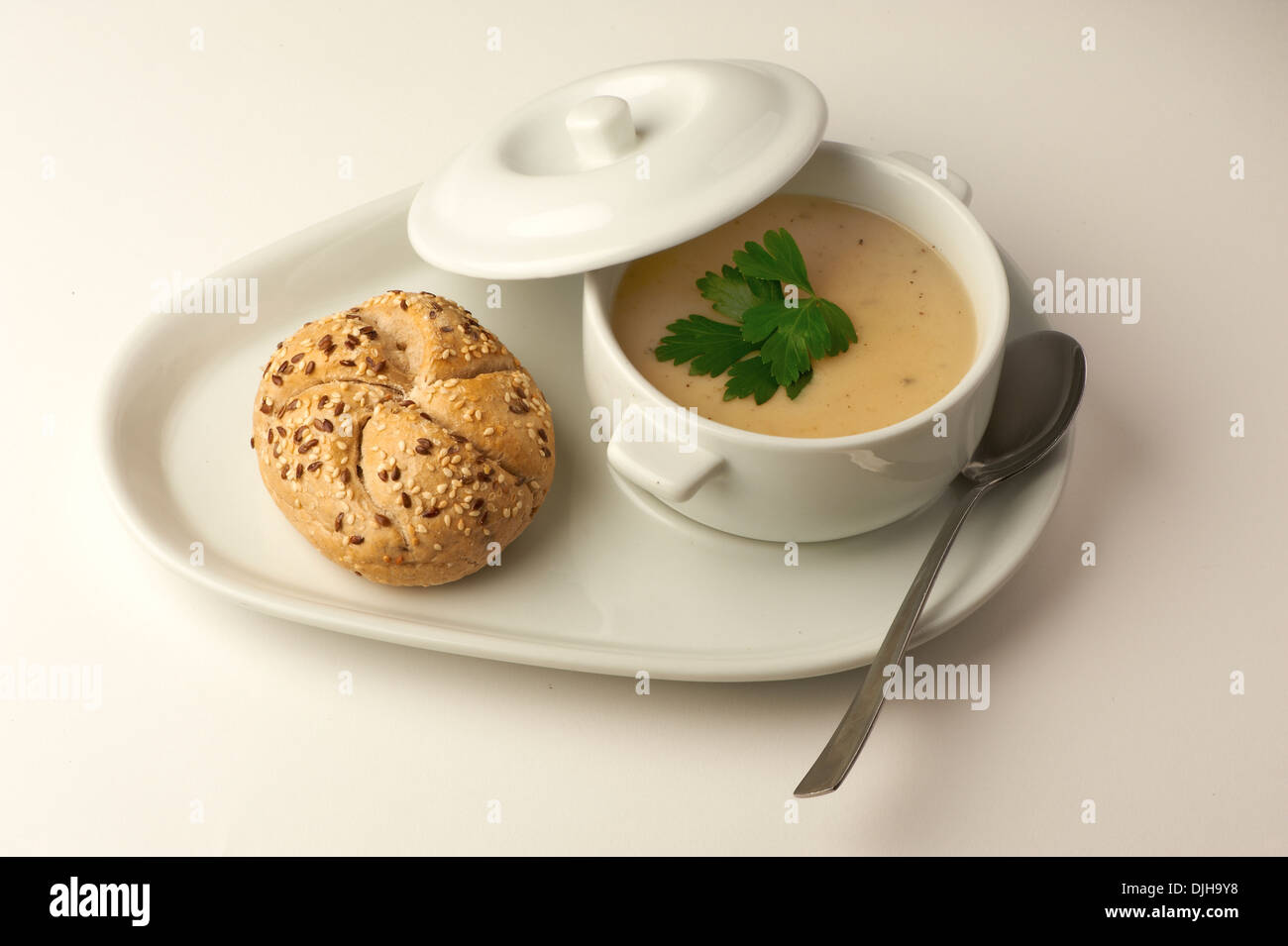 Chicken soup with a bread roll Stock Photo Alamy