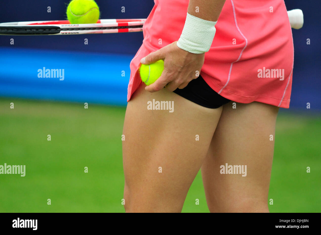 Samantha Stosur (Australia) tucking a spare ball under her skirt before serving. Eastbourne 2013 Stock Photo