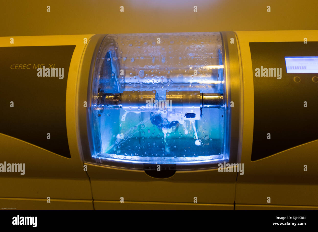 A CEREC crown making machine grinds a new tooth for a patient in a