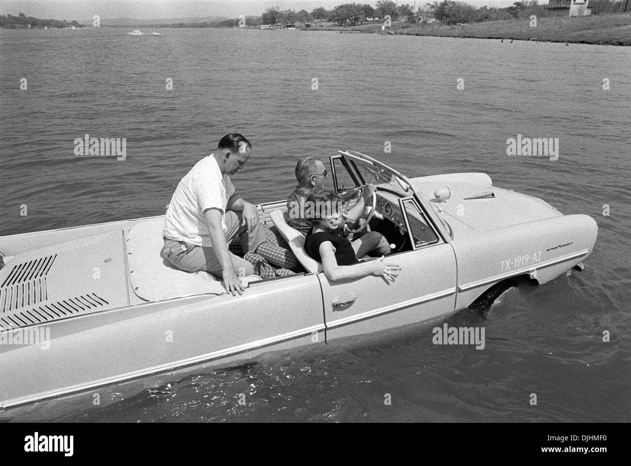 US President Lyndon B. Johnson drives his Amphicar with Eunice Kennedy Shriver and Paul Glynn at the Haywood Ranch April 10, 1965 in Kingsland, Texas. Stock Photo
