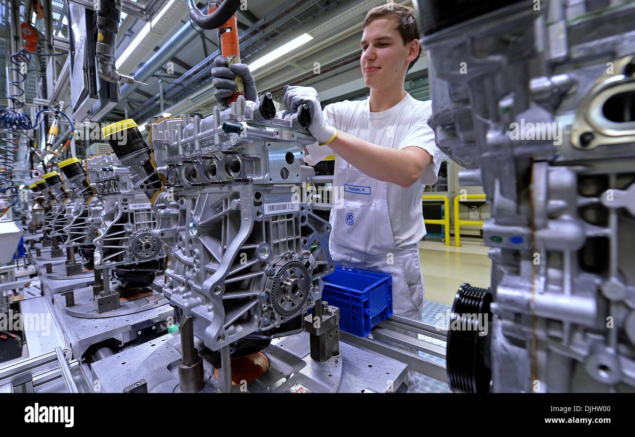 Volkswagen Saxony employee Marcel Thalheim assembles an engine in the ...