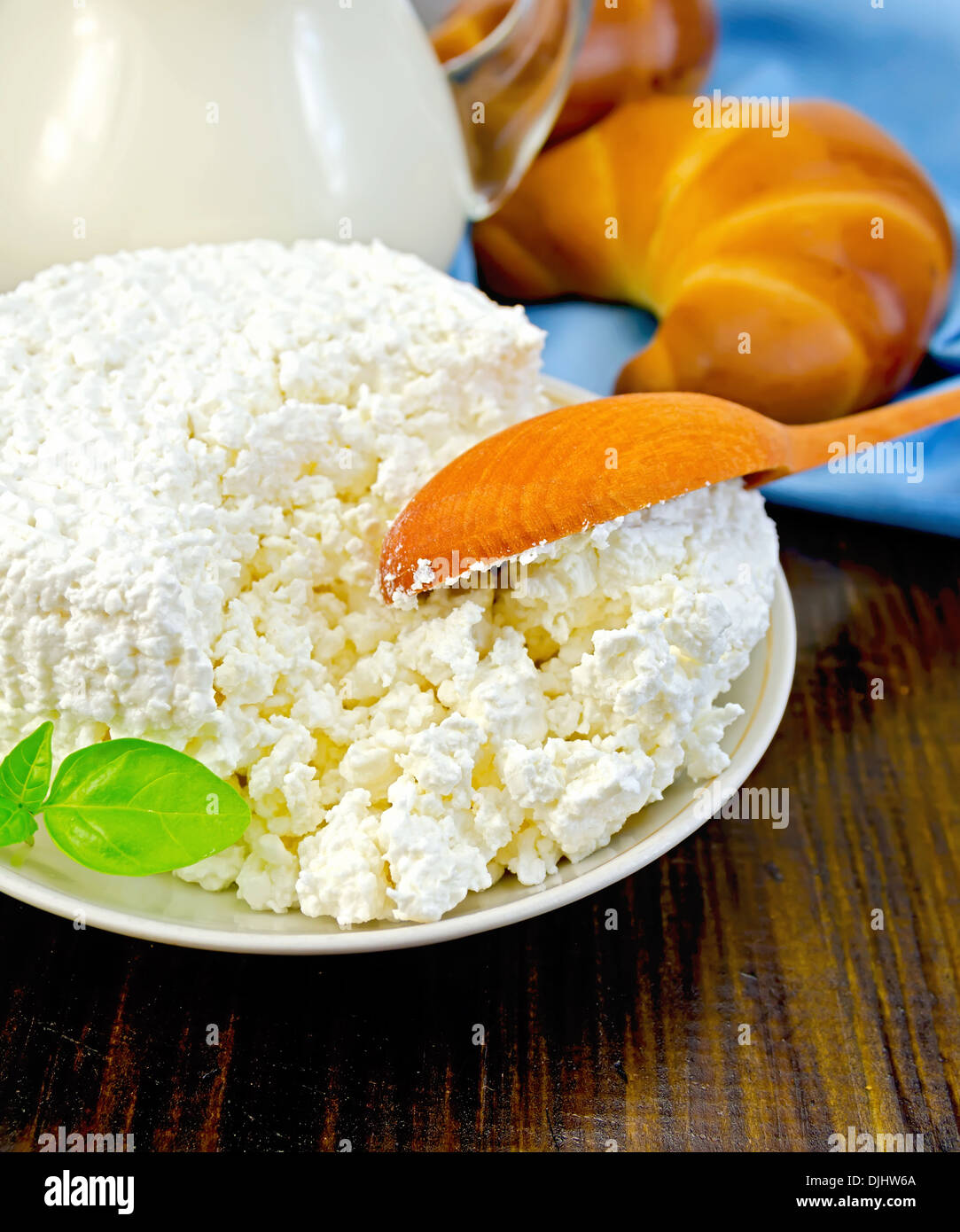 Cottage Cheese In A Saucer With Basil Wooden Spoon Two Bagels A