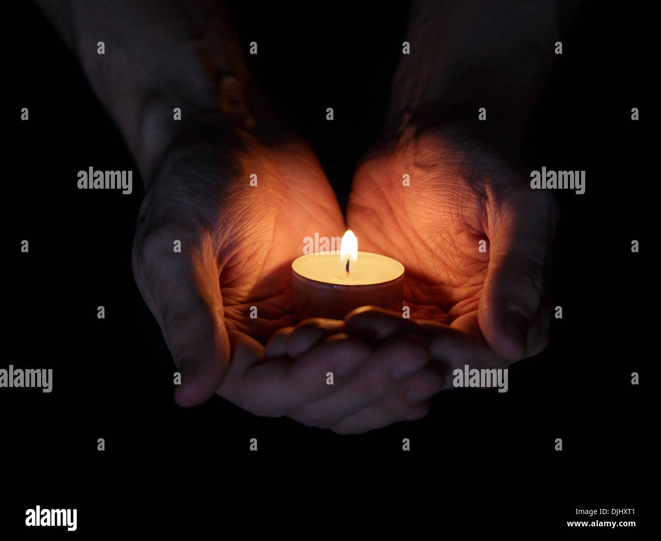 adult man hands holding burning candle in the dark Stock Photo Alamy