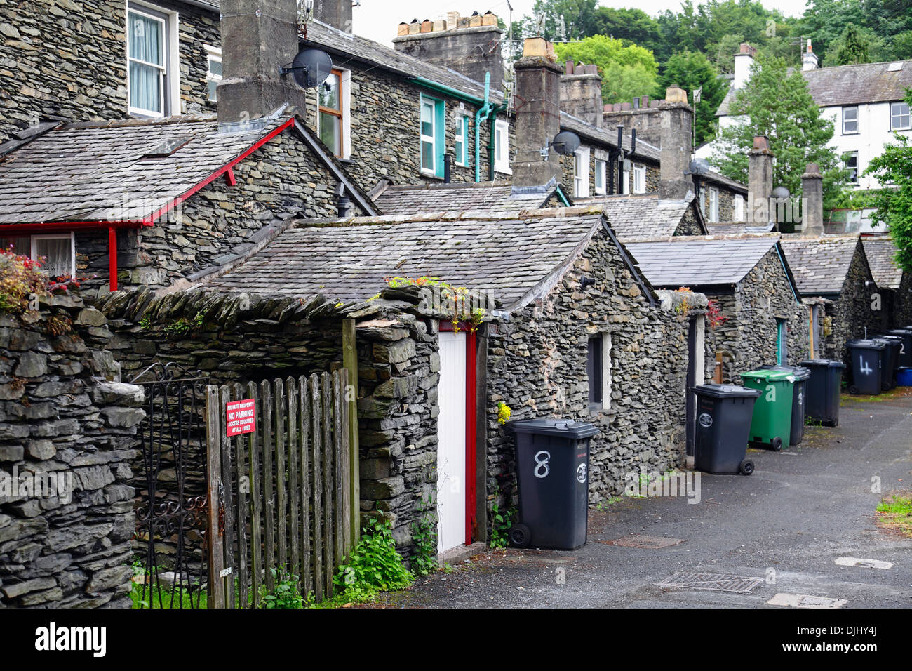 Outhouses on an alley at the back of traditional style houses in Bowness-On-Windermere, the Lake District, Cumbria, England, UK Stock Photo