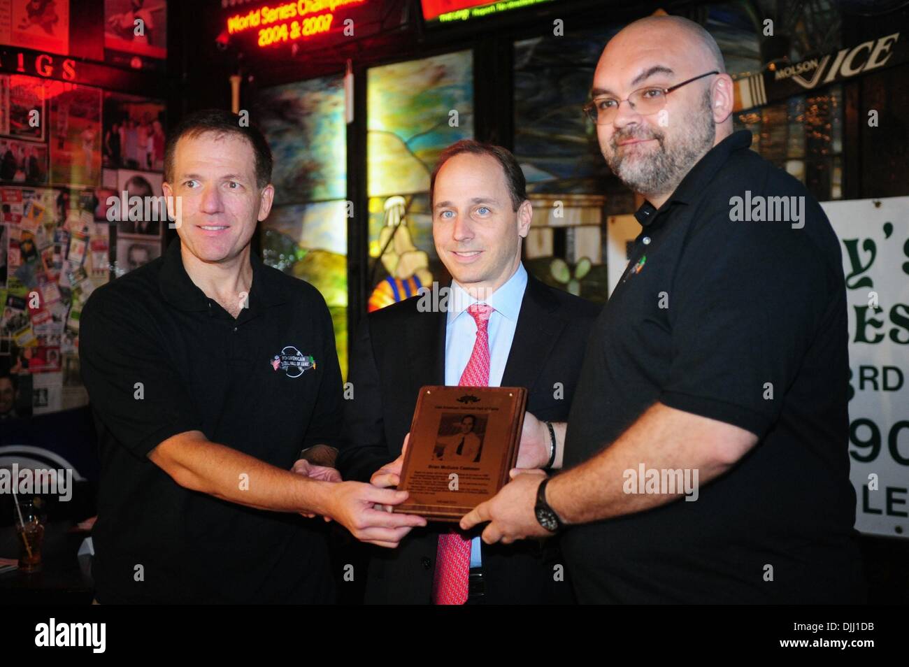 Aug. 06, 2010 - Manhattan, New York, U.S. - Inductee NY Yankees GM BRIAN CASHMAN (C) with curator John Mooney (L) and owner of Foley's Shaun Clancey (R) at the ceremony as Irish Americans are inducted into the Irish American Baseball Hall of Fame at Foley's NY Pub & Restaurant on West 33rd Street. (Credit Image: Â© Bryan Smith/ZUMApress.com) Stock Photo