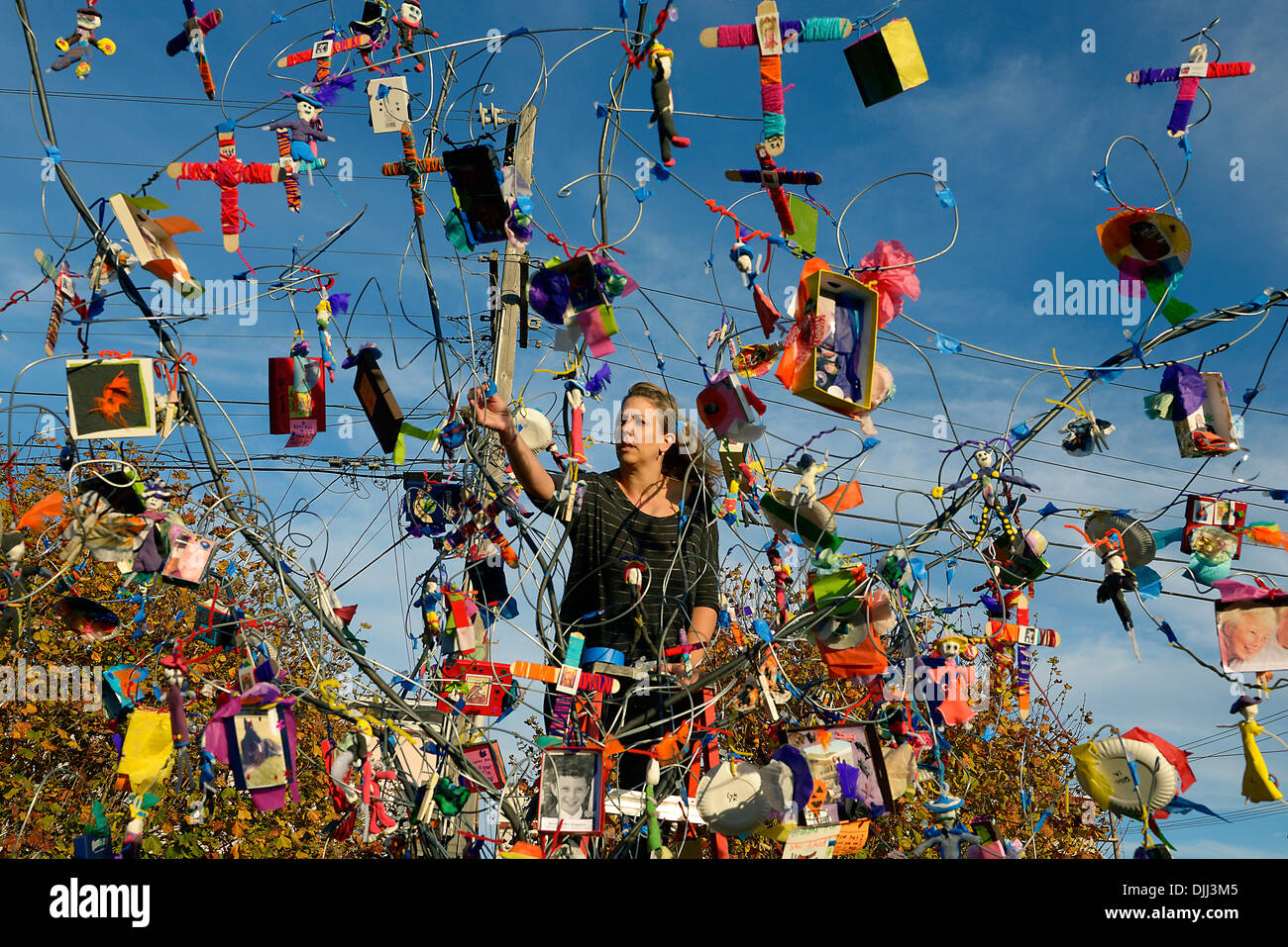 woman places mementoes on tree in san francisco day of the dead Stock Photo