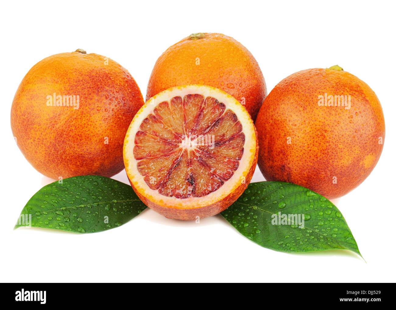 Ripe red blood oranges with cut and green leaves isolated on white background. Closeup. Stock Photo