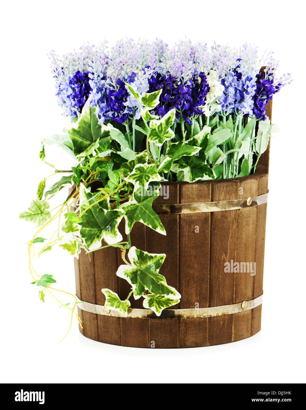 Composition of artificial flowers in old wooden barrel isolated on white background. Closeup. Stock Photo