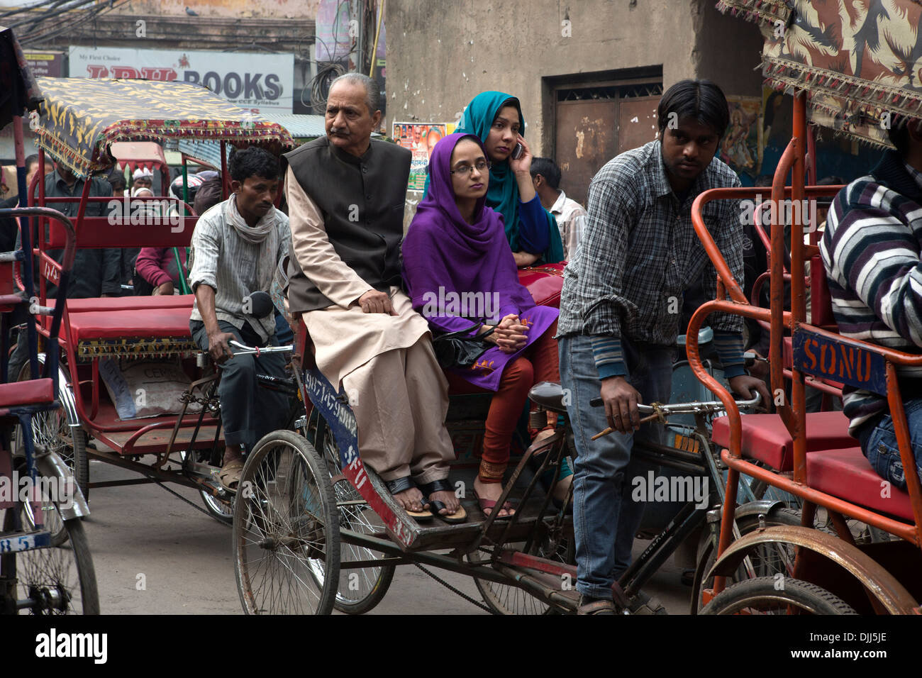 Several rickshaw walking through traffic street in Old Delhi. Stock Photo