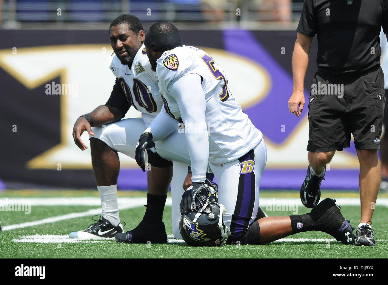 August 07, 2010: Baltimore Ravens linebacker Ray Lewis (52) and defensive end Trevor Pryce (90) take a knee during Ravens training camp at M&T Bank Stadium in Baltimore, MD...Mandatory Credit: Russell Tracy / Southcreek Global (Credit Image: © Russell Tracy/Southcreek Global/ZUMApress.com) Stock Photo