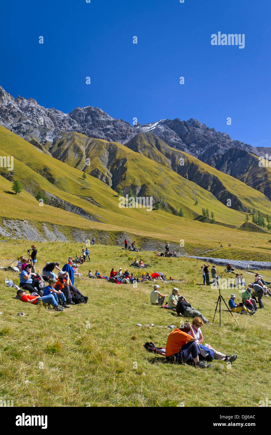 Tourists resting in the mountain valley Val Trupchun, Swiss National Park at Graubünden / Grisons in the Alps, Switzerland Stock Photo