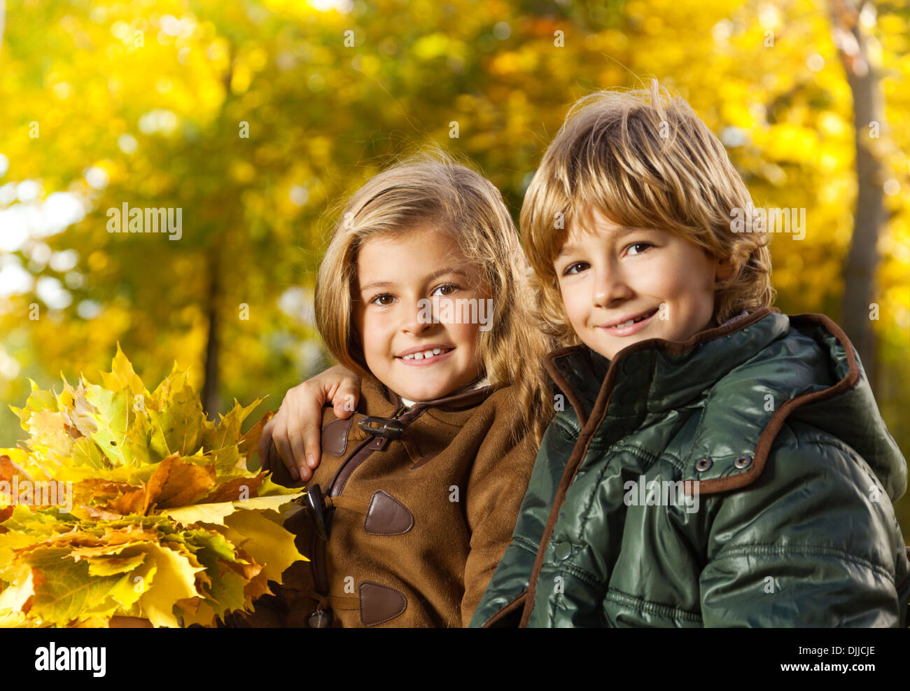 Close Portrait Of Two Happy Blond Kids Boy And Girl Twin Siblings With Bouquet Of Leaves Stock Photo Alamy