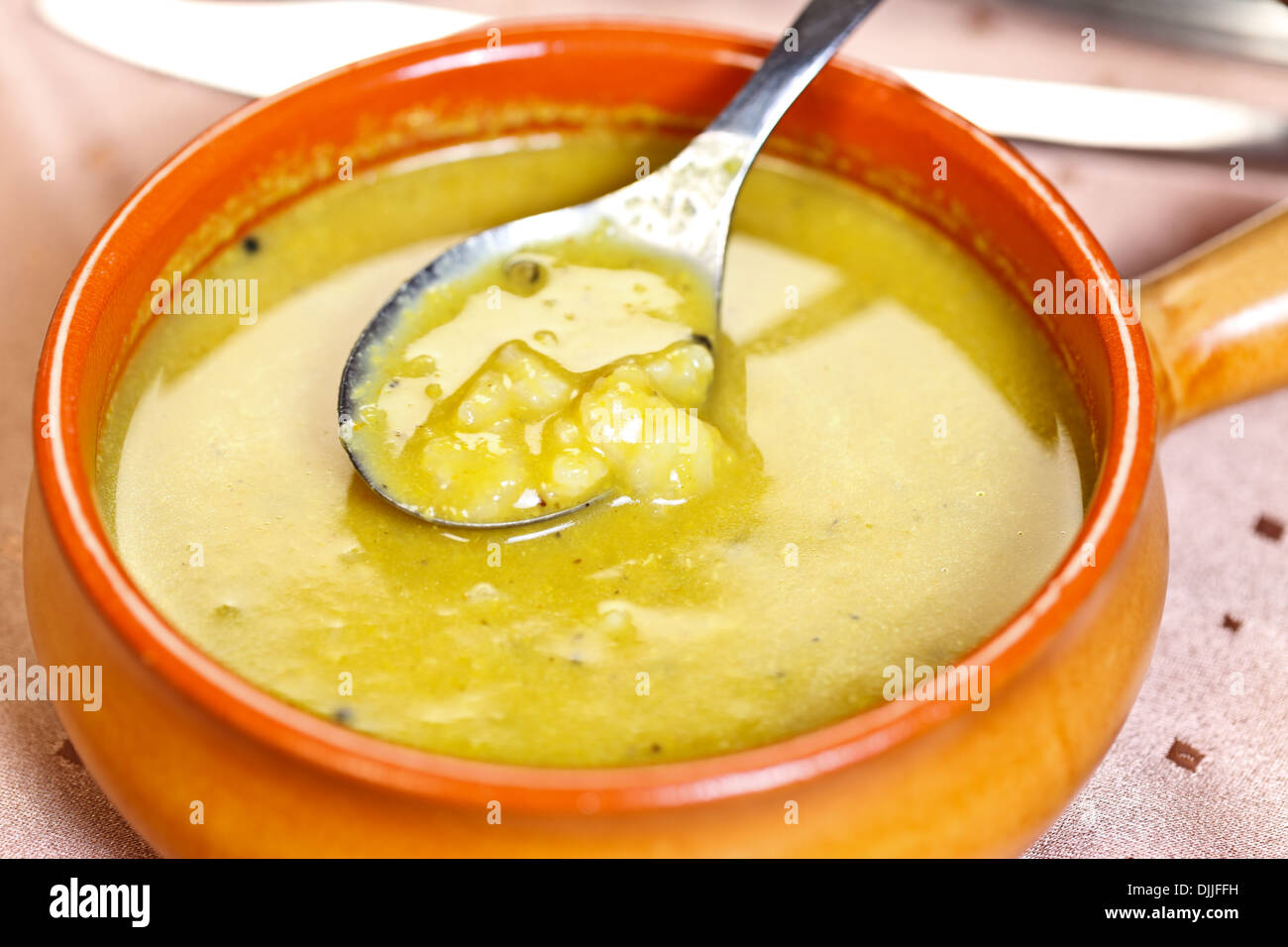 Curry flavored lentil soup with crushed black pepper and boiled rice