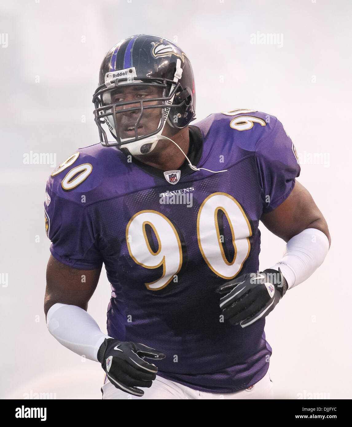 Aug. 12, 2010 - Baltimore, Maryland, United States of America - Aug 12, 2010: Baltimore Raven's defensive end Trevor Pryce (#90) enters the stadium in a cloud of smoke in the pregame introductions against the Carolina Panthers.  The Ravens defeated the Panthers 17-12 as the teams played their first preseason game at M & T Bank Stadium in Baltimore, Maryland. (Credit Image: Â© South Stock Photo