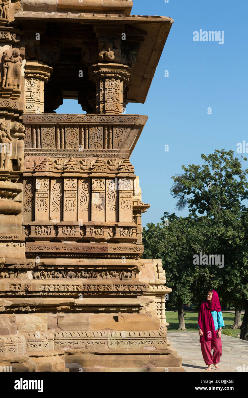 A tourist walks along the Kandariya Mahadev temple. It is the most spectacular an largest of all the temples in Khajuraho. Stock Photo