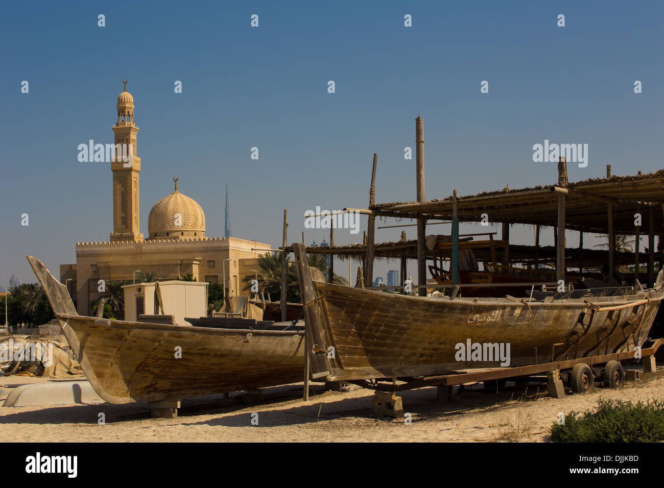 2 Racing Dhows and Mosque with Burj Khalifa in the distance, Jumeirah, Dubai, UAE Stock Photo