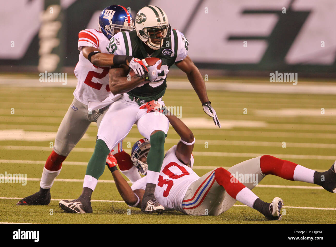 27 September 2009: Tennessee Titans #28 Chris Johnson gets caught. The New  York Jets defeated the Tennessee Titans 24-17 at Giants Stadium in  Rutherford, New Jersey. In honor of AFL Legacy weekend