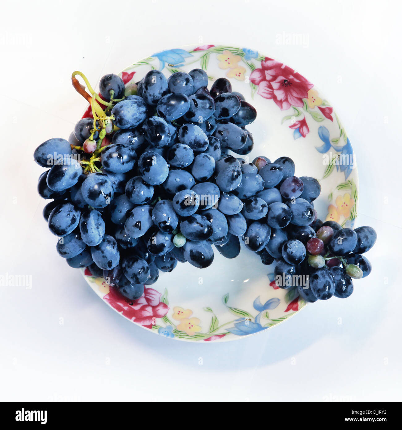 Grapes on plate isolated, with path in front of white background Stock Photo