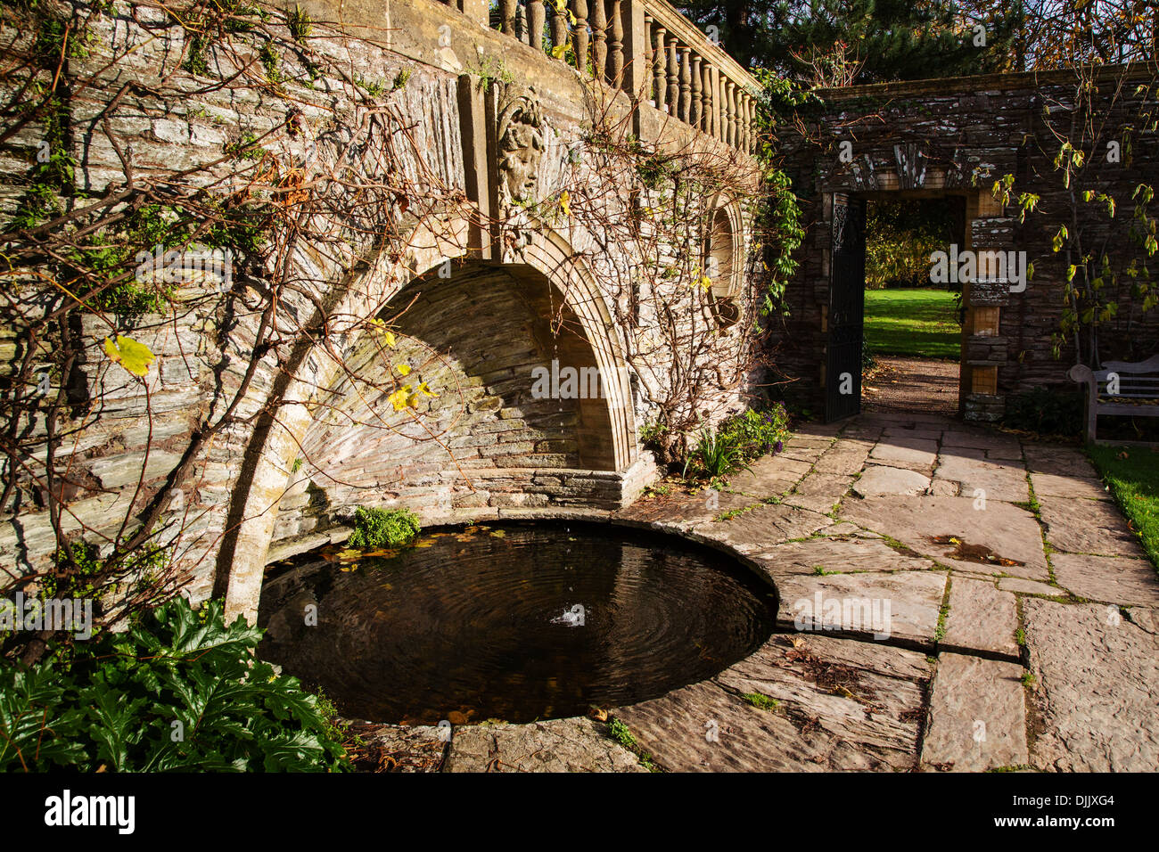 Female head keystone over a pool designed by Edwin Lutyens in Hestercombe Gardens near Taunton Somerset UK Stock Photo