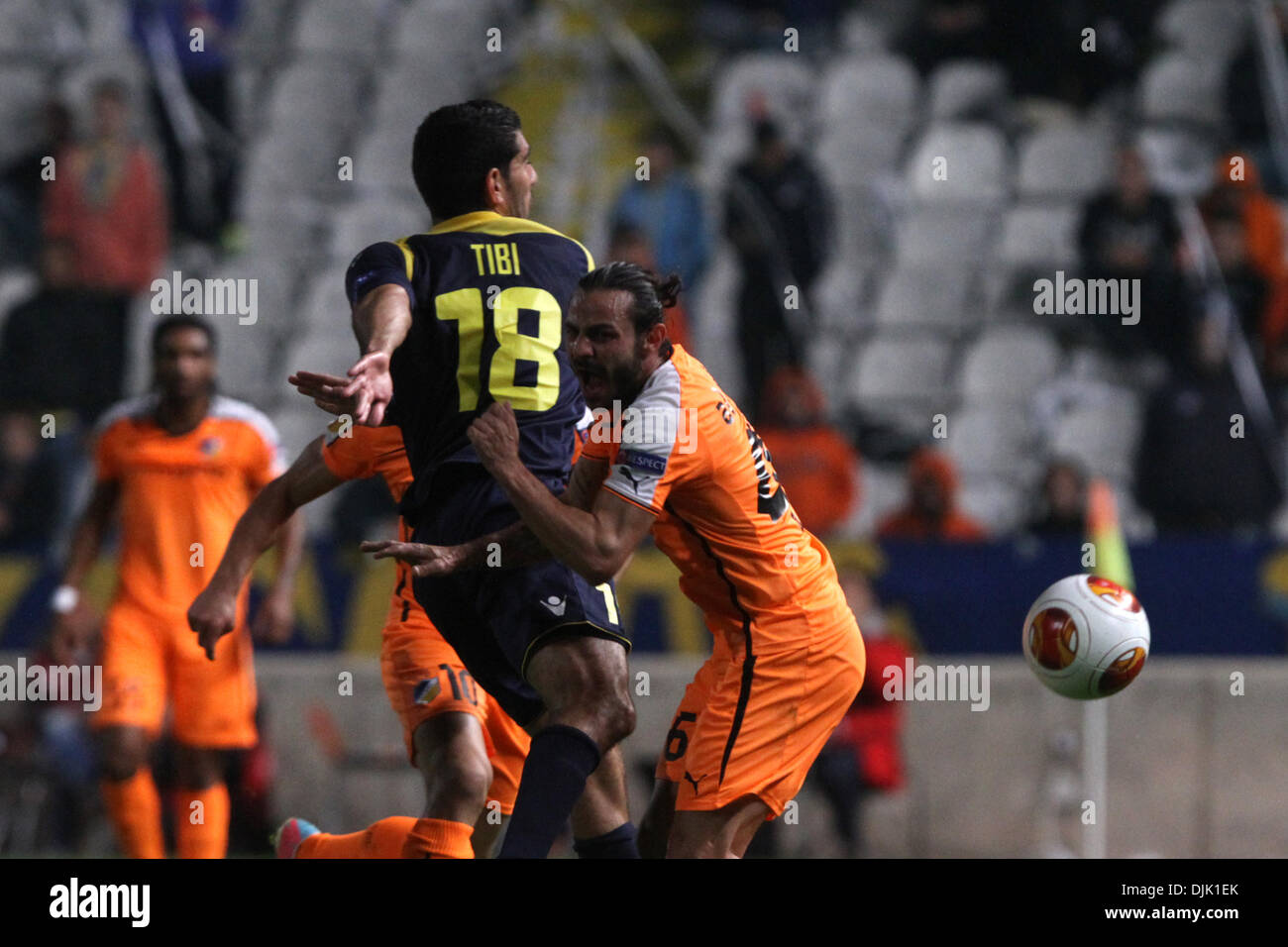 Nicosia, Cyprus. 28th Nov, 2013. Apoel FC player Stathis Aloneftis  and Maccabi Tel Aviv Fc  player Eytan Tibi fight for the ball during their Europa League  soccer match at GSP stadium in Nicosia, Cyprus, Thursday, Nov. 28, 2013 Credit:  Yiannis Kourtoglou/Alamy Live News Stock Photo