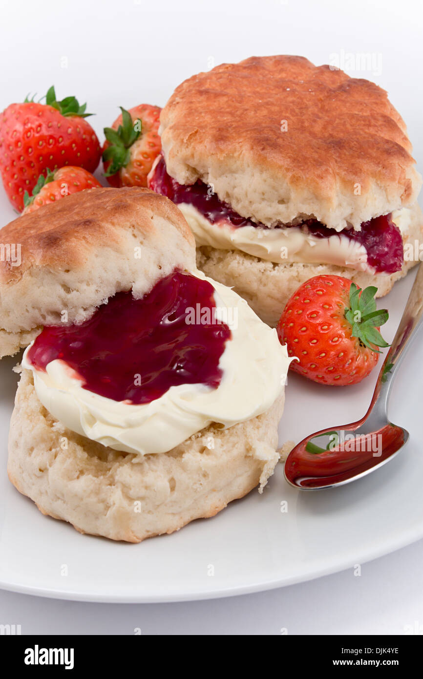 Traditional Afternoon Tea of Devonshire scones topped with clotted cream and strawberry jam often served with coffee or tea Stock Photo
