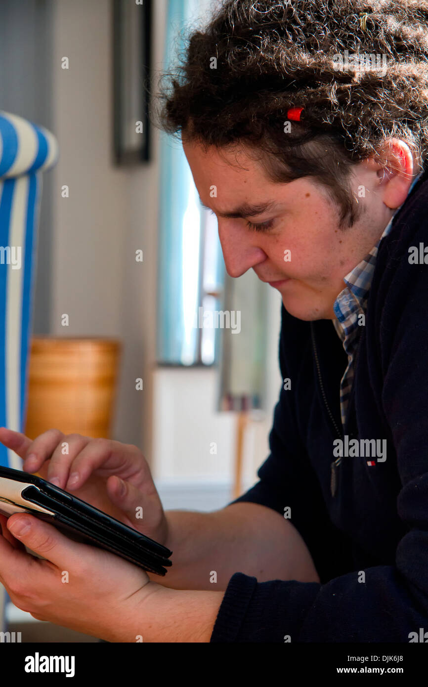 Man reading from an iPad or tablet Stock Photo