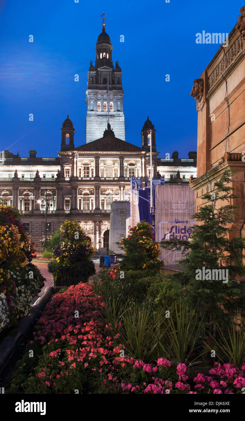 Buildings And A Tower Against A Blue Sky With Flowers And Plants In A Landscaped Garden; Glasgow