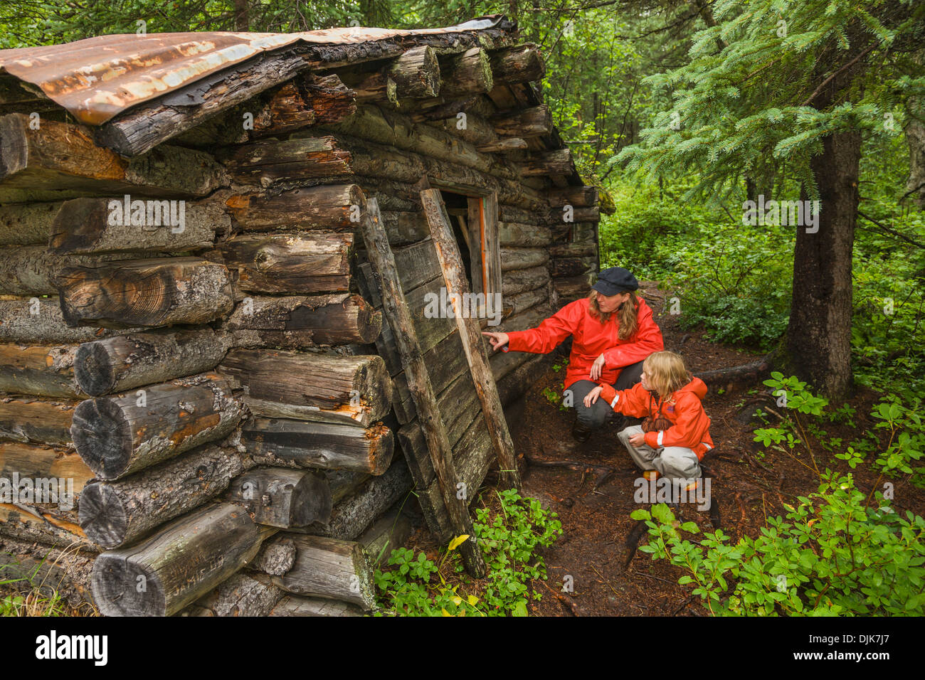 Woman And Her Daughter Inspecting A Cabin Built In 1958 By Red