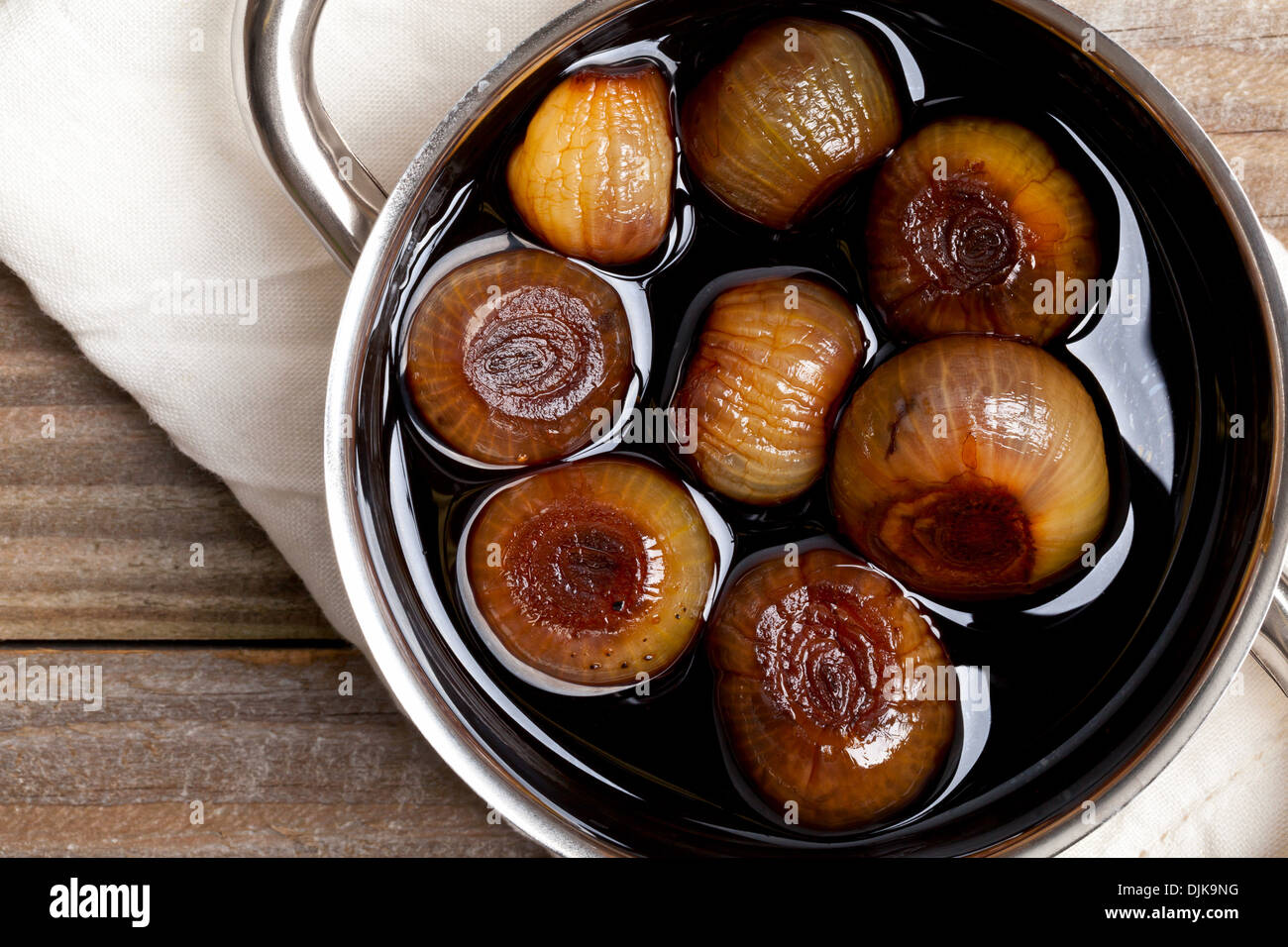 Pickling onions pickled in dark balsamic vinegar Stock Photo