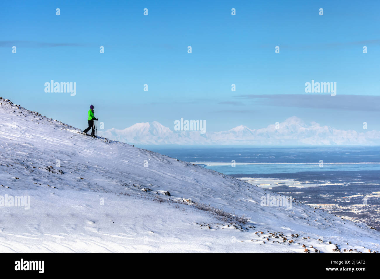 Woman Snowshoeing On Blueberry Hill At The Glen Alps Area Of Chugach State Park. Anchorage